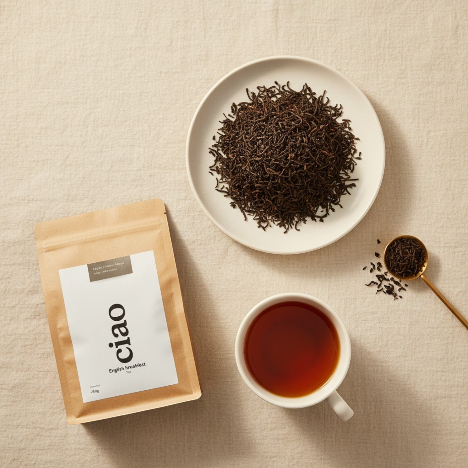 Say Ciao Coffee English Breakfast loose leaf tea in a brown pouch, on a white plate, and in a white cup.