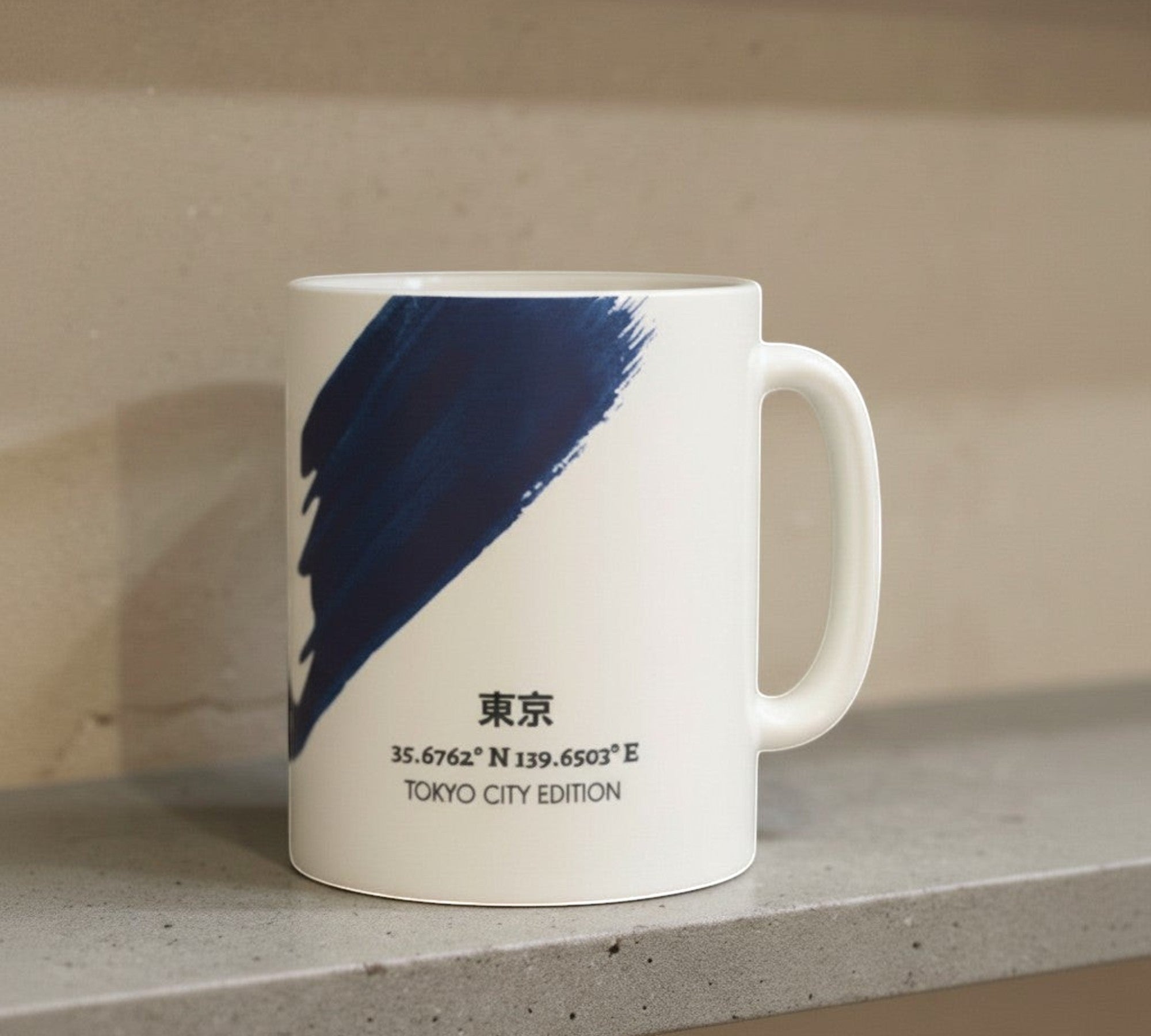 Say Ciao Coffee white ceramic mug with indigo brushstroke design and Tokyo coordinates.