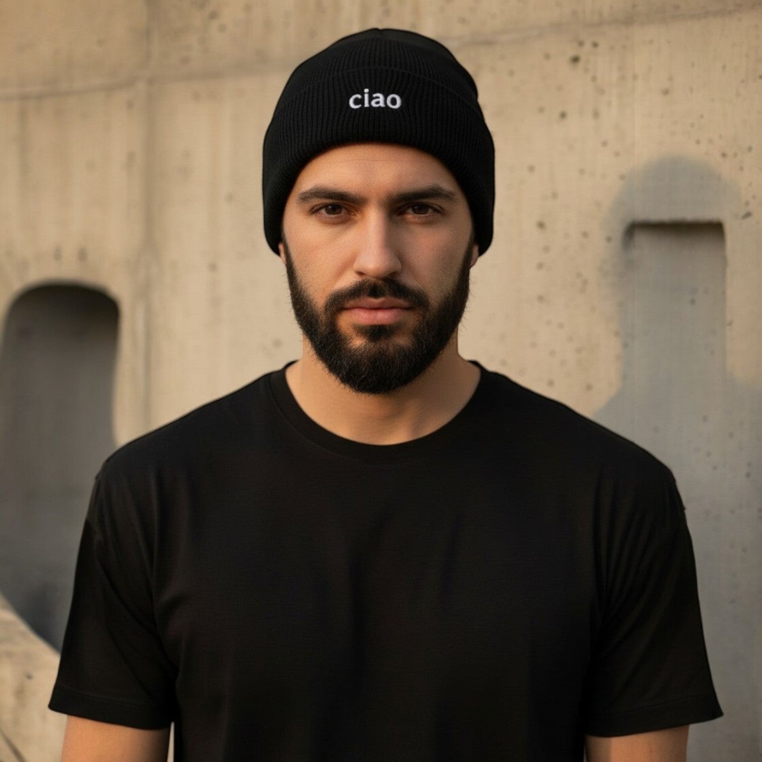 Black cotton-acrylic blend beanie with a ribbed cuff and embroidered "ciao" logo, worn by a man.