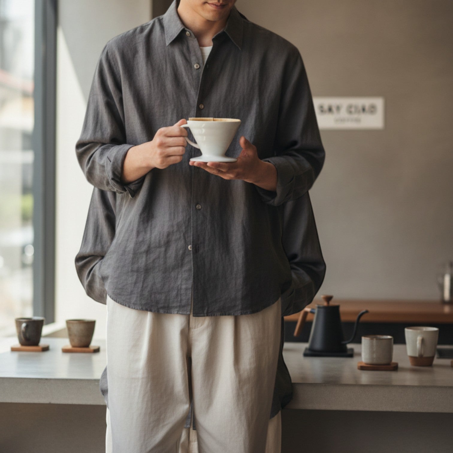Say Ciao Coffee Tokyo Edition white plastic V60 pour-over coffee dripper, size 02, held by a person.